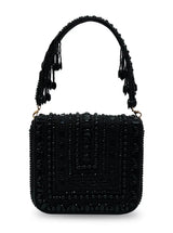 Black Megan flap-over bag by The Tan Clan featuring a sleek design and top flap closure, perfect for stylish everyday use.