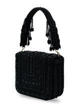 Black Megan flap-over bag by The Tan Clan, stylish flap bag with sleek design and top handle for versatile carry.