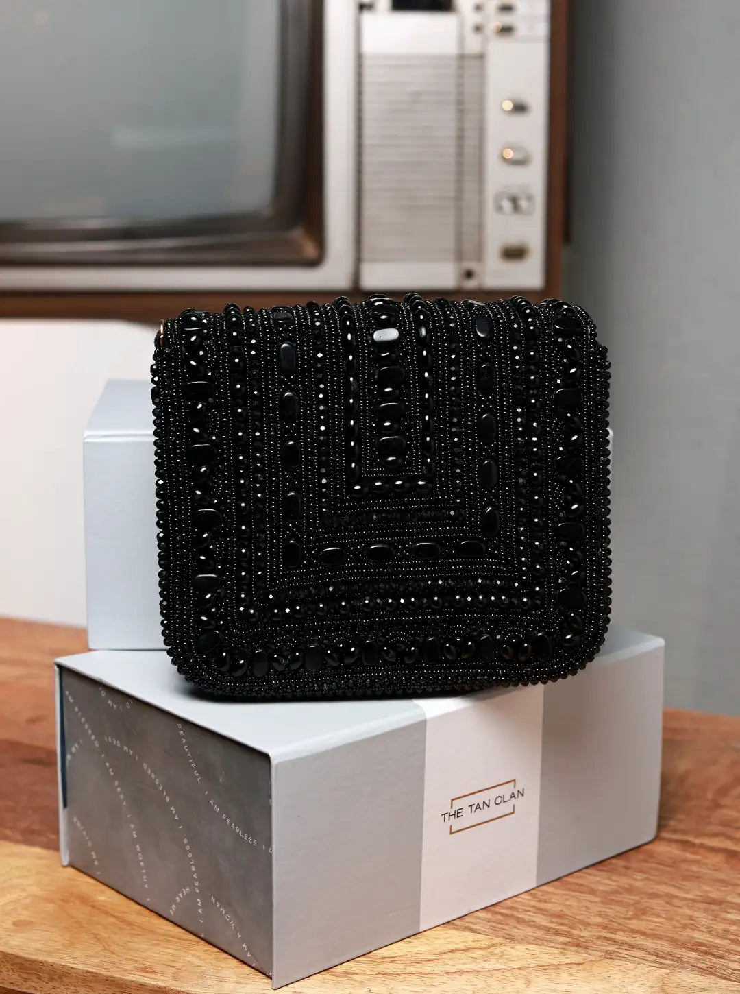 Megan black flap-over bag by The Tan Clan featuring a sleek design and top flap closure, perfect for stylish everyday use.
