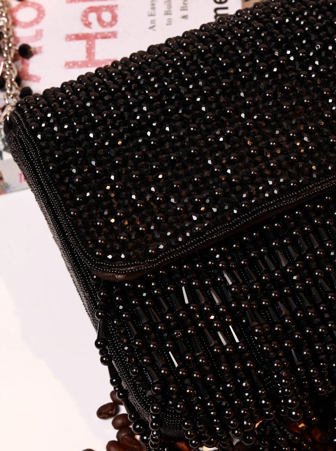Mira Black Flap Over Bag by The Tan Clan showing a stylish black leather flap bag with a silver clasp and adjustable strap.
