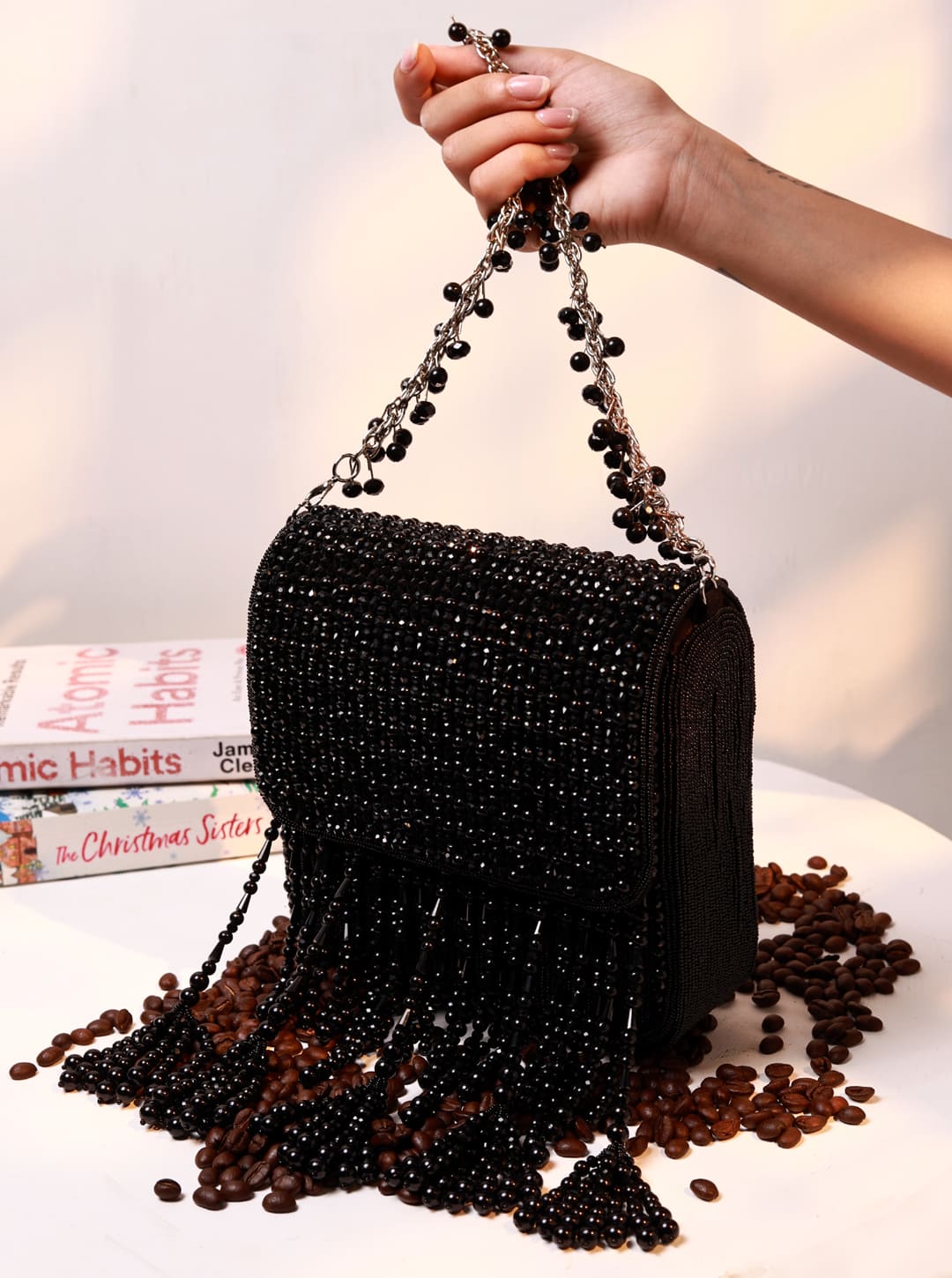 The Tan Clan Mira Black Flap Over Bag featuring a sleek flap design, stylish black leather, and adjustable shoulder strap.