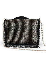 Black Sylvie flap-over bag by The Tan Clan featuring a stylish design and top flap closure.