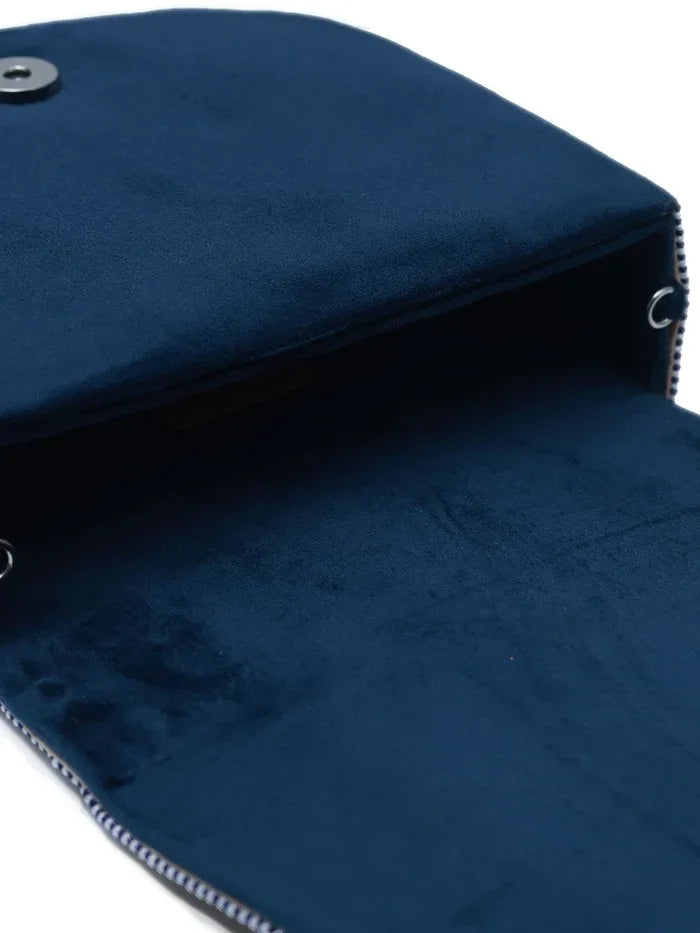 Blue flap-over bag with handle from The Tan Clan, featuring a sleek design and spacious interior for everyday use.