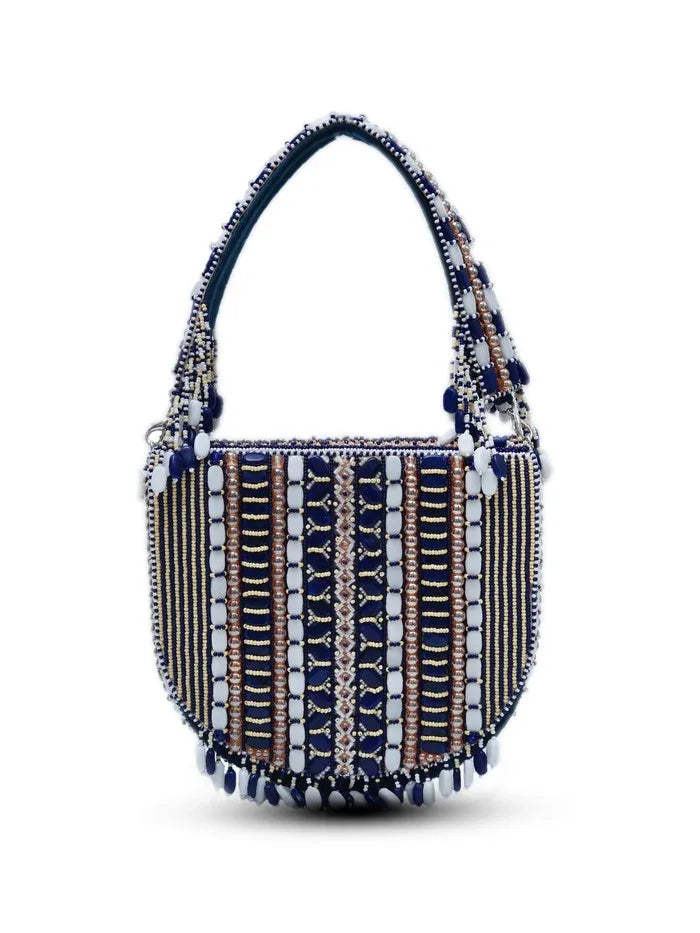 Blue flap-over bag with handle from The Tan Clan featuring a sleek design and structured shape.