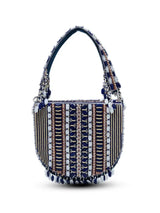 Blue flap-over bag with handle from The Tan Clan featuring a sleek design and structured shape.