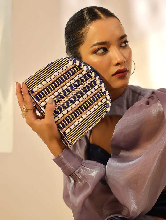 Blue Asma flap-over bag with handle from The Tan Clan, shown with its stylish design and spacious interior.