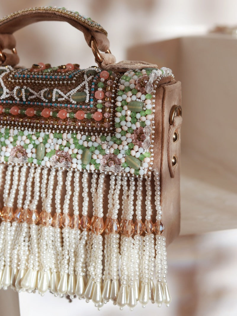 Beige Kiara flap-over bag with handle from The Tan Clan, featuring a stylish design and top handle for versatile carrying.