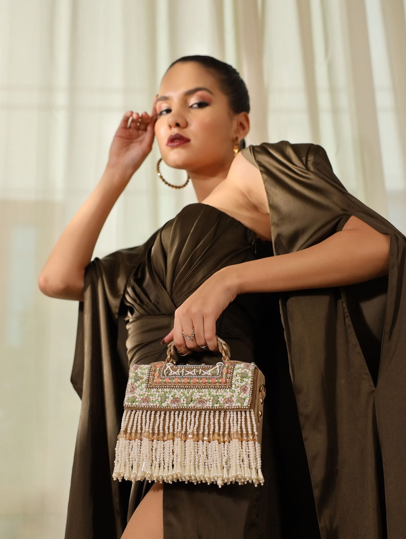 Beige Kiara flap-over bag with handle from The Tan Clan, featuring a structured design and top handle for versatile style.