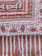 Pink Kiara flap-over bag with handle by The Tan Clan, showing its stylish design and soft leather texture.