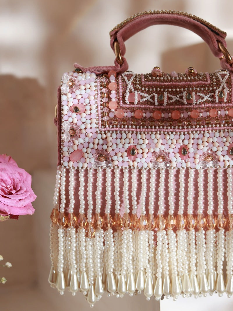Pink Kiara flap-over bag with handle from The Tan Clan, featuring a stylish design and spacious interior.