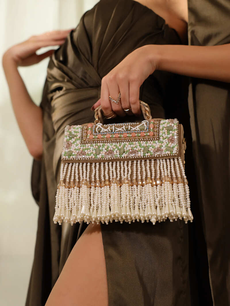 Beige Kiara flap-over bag with handle by The Tan Clan, showcasing a stylish and spacious handbag with a flap closure.