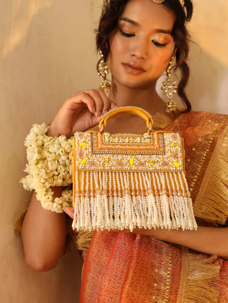 Beige Kiara flap-over bag with handle from The Tan Clan, featuring a sleek design and durable material.