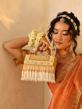 Yellow Kiara flap-over bag with handle from The Tan Clan, showcasing its stylish design and vibrant color.