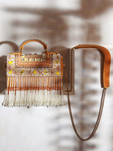 Yellow flap-over bag with handle from The Tan Clan, featuring a stylish design and spacious interior.
