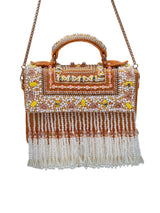 Yellow flap-over bag with handle from The Tan Clan, featuring a stylish design and spacious interior.