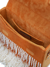 Yellow Kiara flap-over bag with handle by The Tan Clan, showing a stylish design and vibrant color against a plain background.
