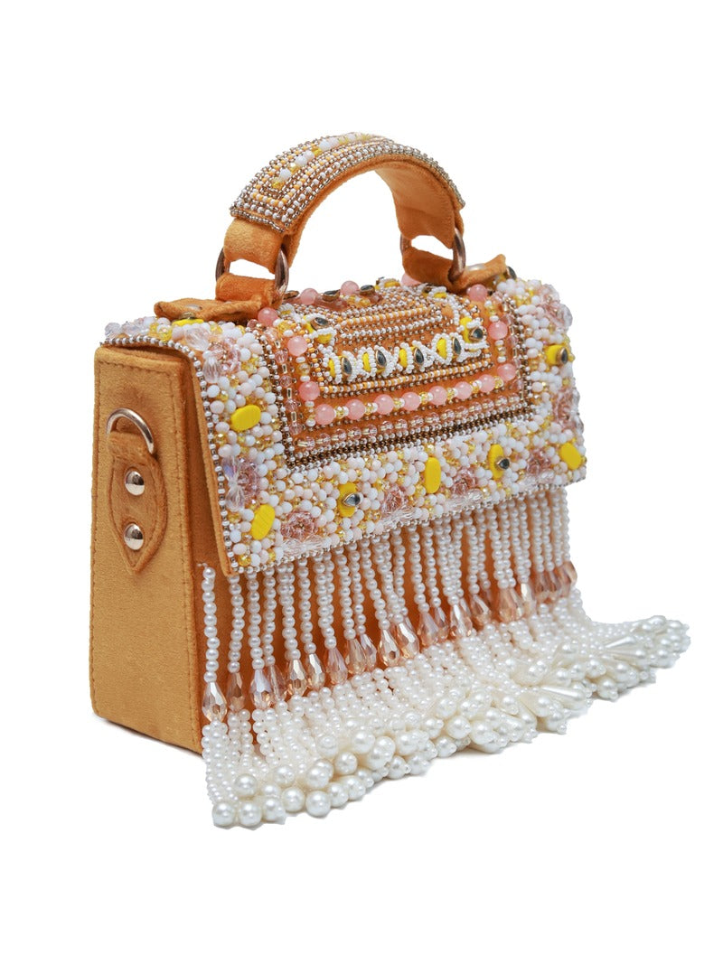 Yellow Kiara flap-over bag with handle from The Tan Clan, featuring a stylish design and secure flap closure.