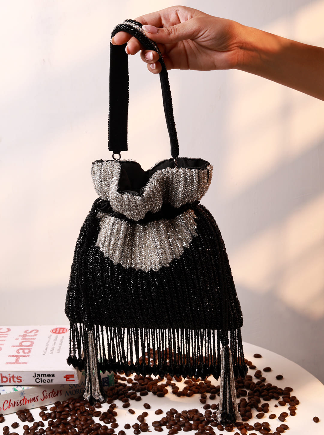 Aarna black Potli bag by The Tan Clan featuring intricate design and traditional drawstring closure, perfect for festive occasions.