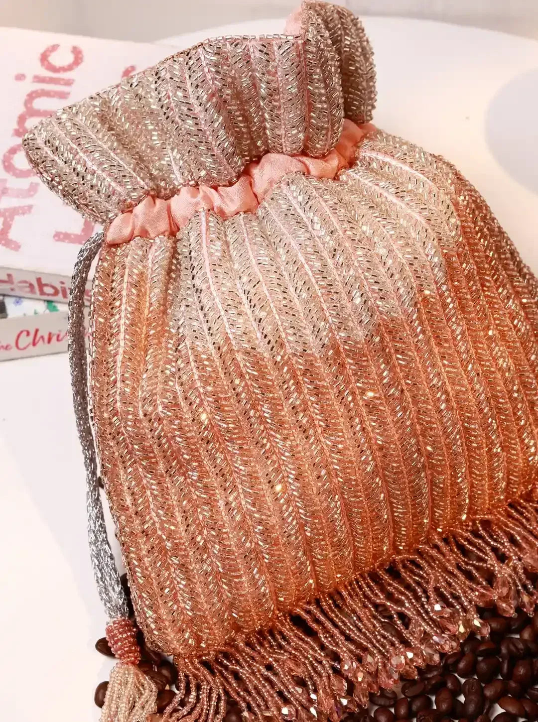 Aarna pink potli bag from The Tan Clan with decorative tie closure and traditional design, perfect for festive occasions.