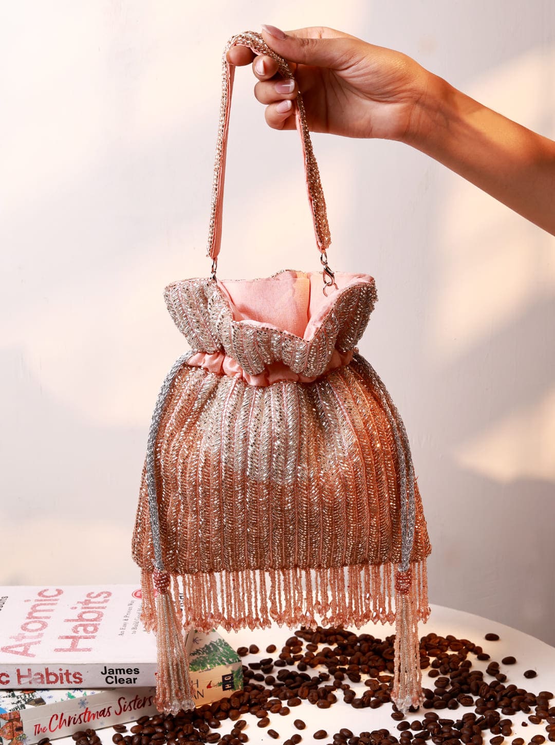 Aara Pink Potli Bag by The Tan Clan featuring traditional Indian embroidery and a drawstring closure.