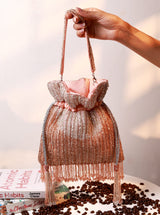 Aara Pink Potli Bag by The Tan Clan featuring traditional Indian embroidery and a drawstring closure.