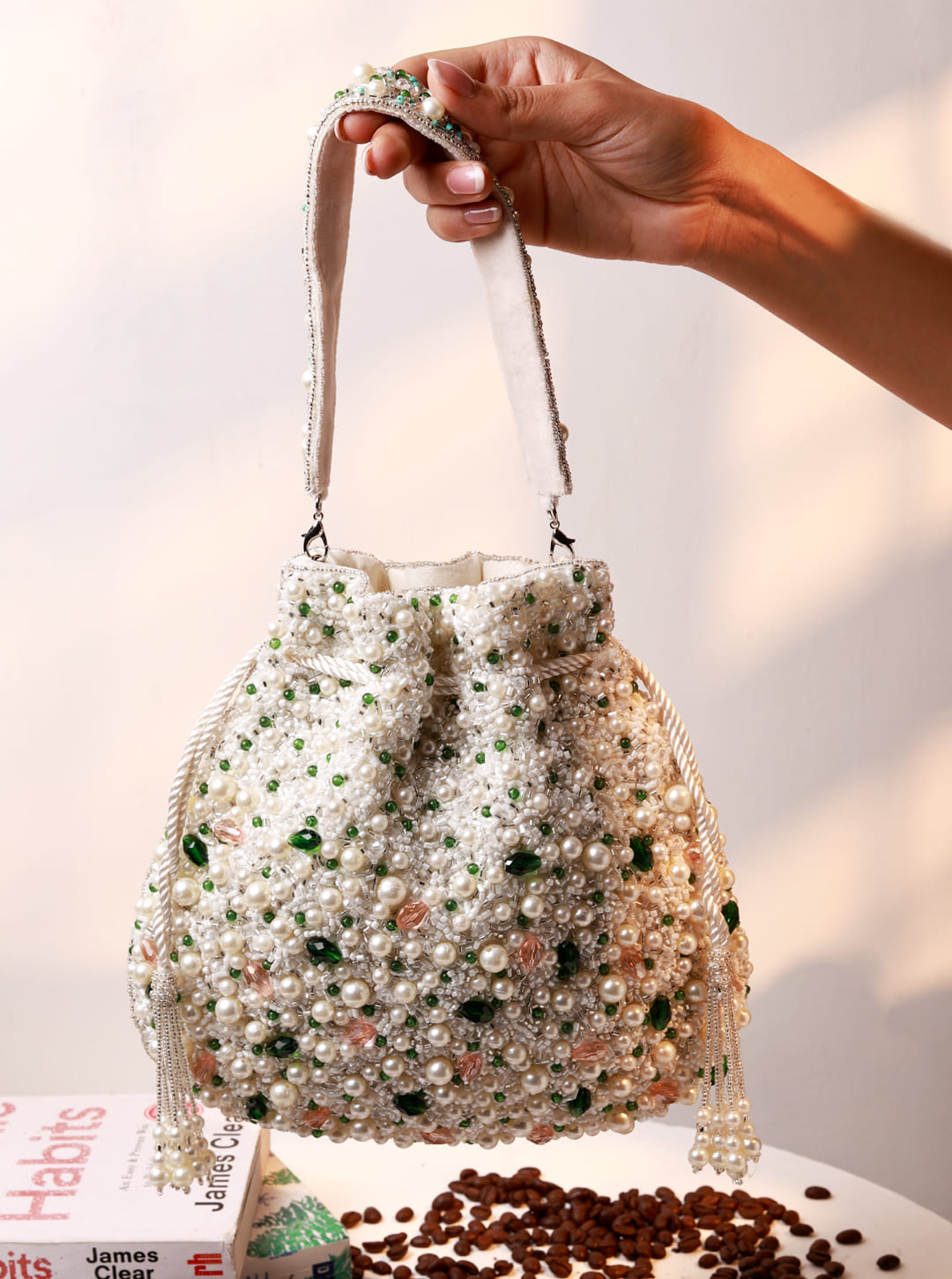 Ayra Pearl Potli Bag by The Tan Clan featuring intricate pearl embroidery and traditional drawstring closure.