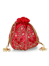 Hot pink Lotus Potli bag by The Tan Clan featuring intricate embroidery and traditional Indian design.