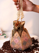 Juhi Lotus Potli bag by The Tan Clan with pearl handle, showcasing intricate lotus design and elegant embellishments.