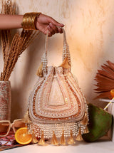 Nora beige tasselled Potli Bag by The Tan Clan with decorative tassels and traditional drawstring closure.