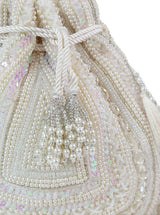 Nora white tasselled Potli bag by The Tan Clan featuring intricate design and decorative tassels, ideal for traditional occasions.