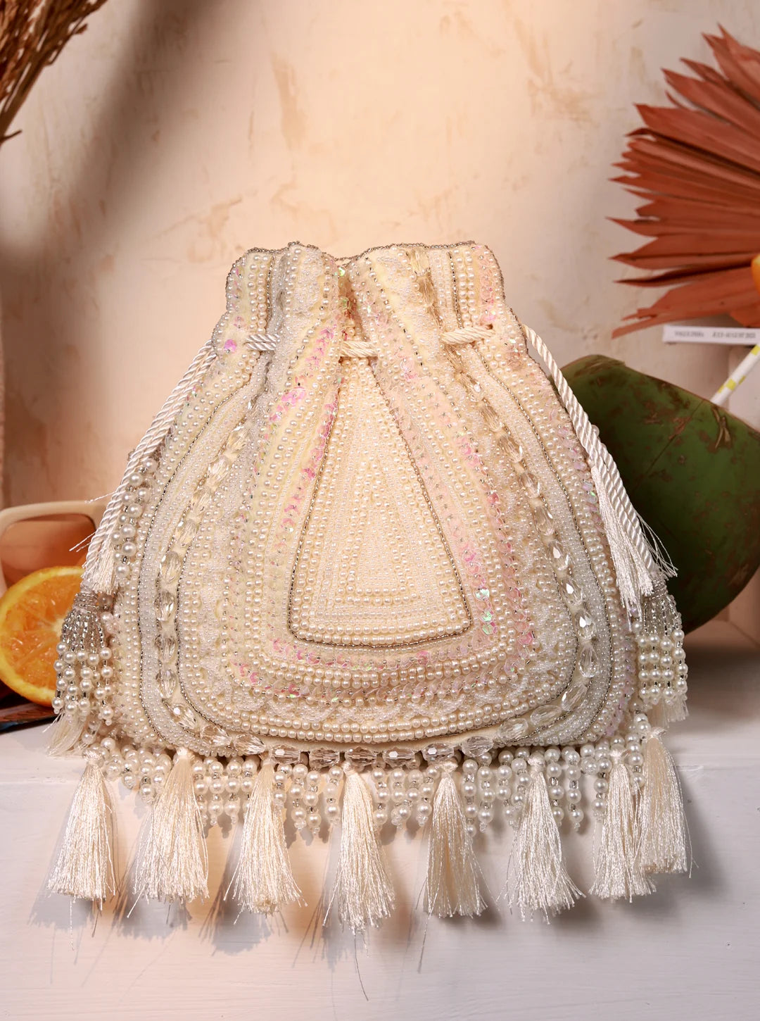 White tasselled Potli Bag from The Tan Clan with decorative tassels and traditional design, perfect for elegant occasions.