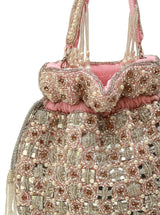 Sehaj pink tasselled potli bag by The Tan Clan featuring decorative tassels and traditional design for special occasions.