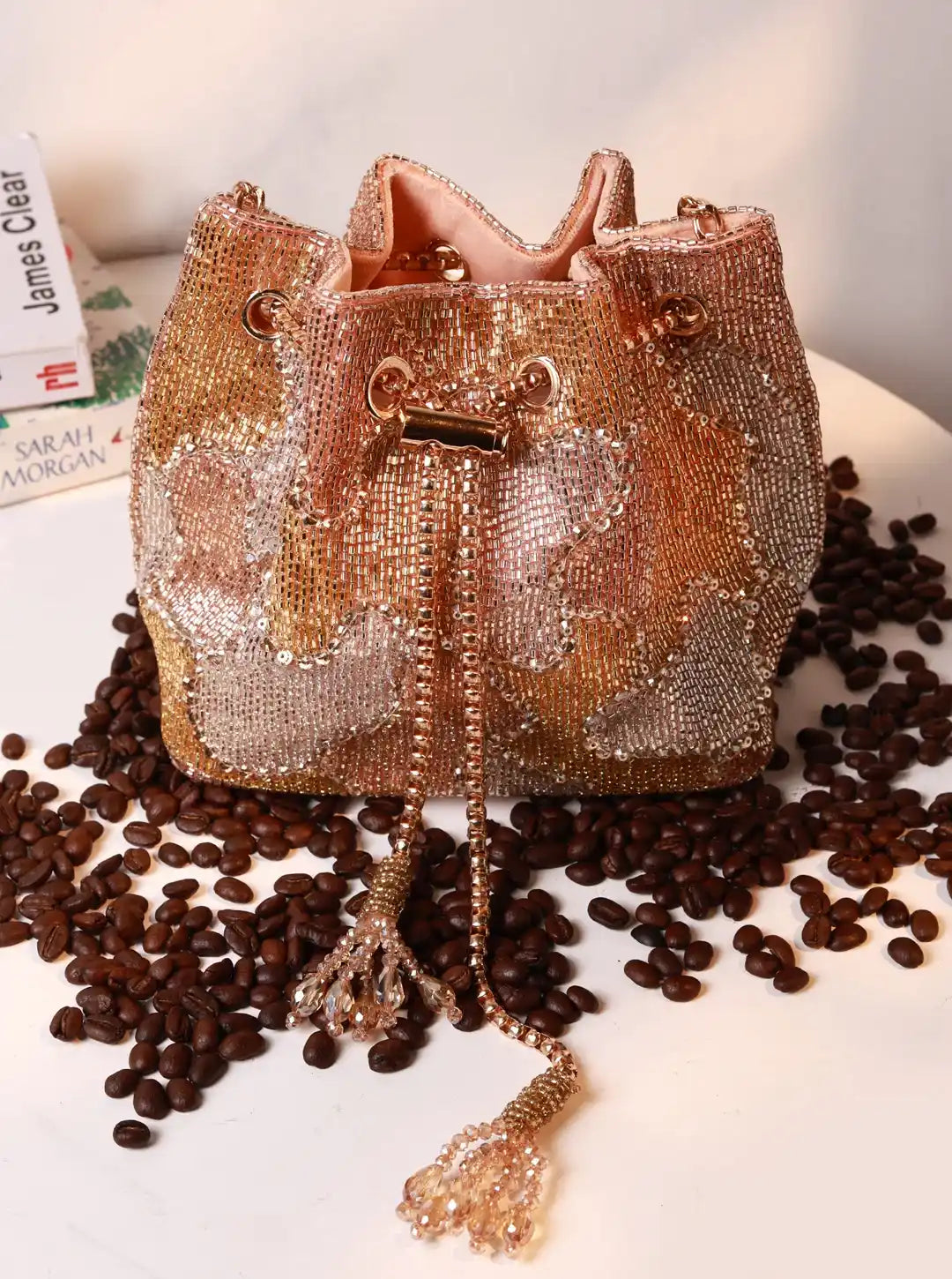 Terra Rose Gold Bucket Bag from The Tan Clan, stylish potli bag with a shiny metallic finish and traditional drawstring closure.