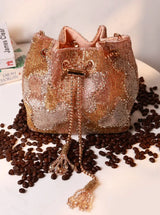 Terra Rose Gold Bucket Bag from The Tan Clan, stylish potli bag with a shiny metallic finish and traditional drawstring closure.