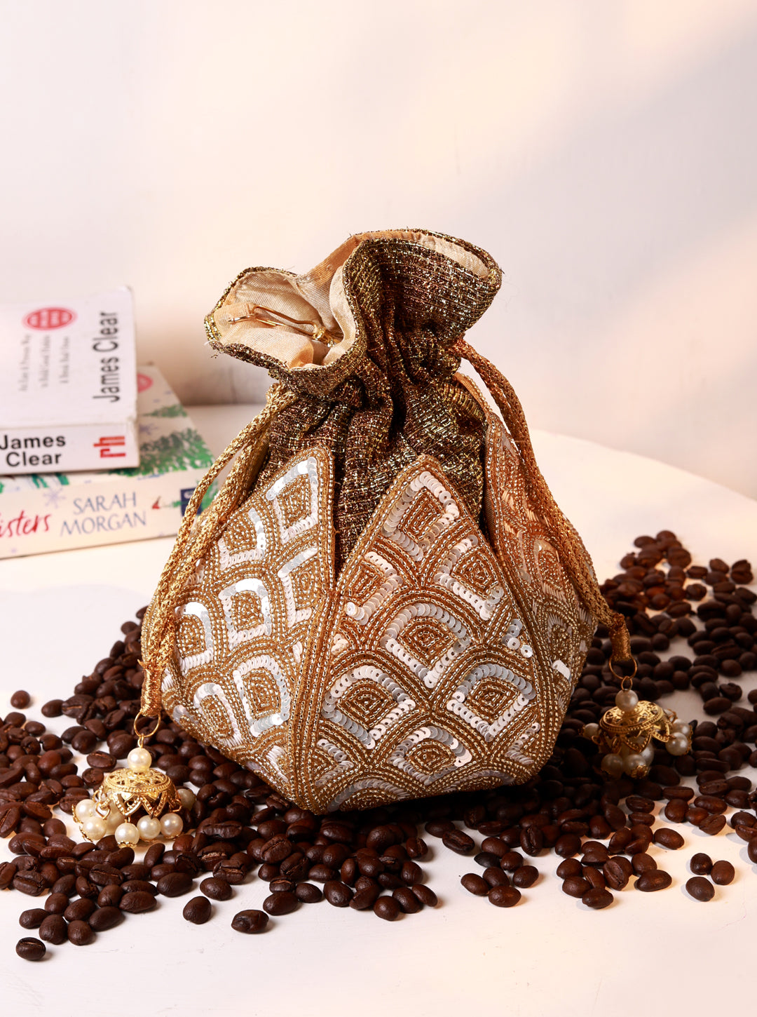 Yana Lotus Potli bag by The Tan Clan featuring a pearl handle and intricate lotus design, traditional Indian accessory.