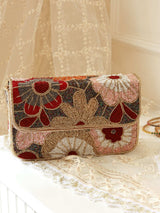Red Daisy floral shoulder bag by The Tan Clan, featuring a colorful floral pattern and adjustable shoulder strap.