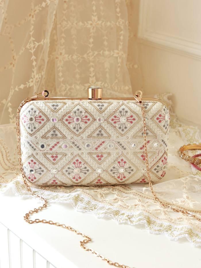 White box clutch by The Tan Clan with a sleek, minimalist design perfect for elegant occasions.