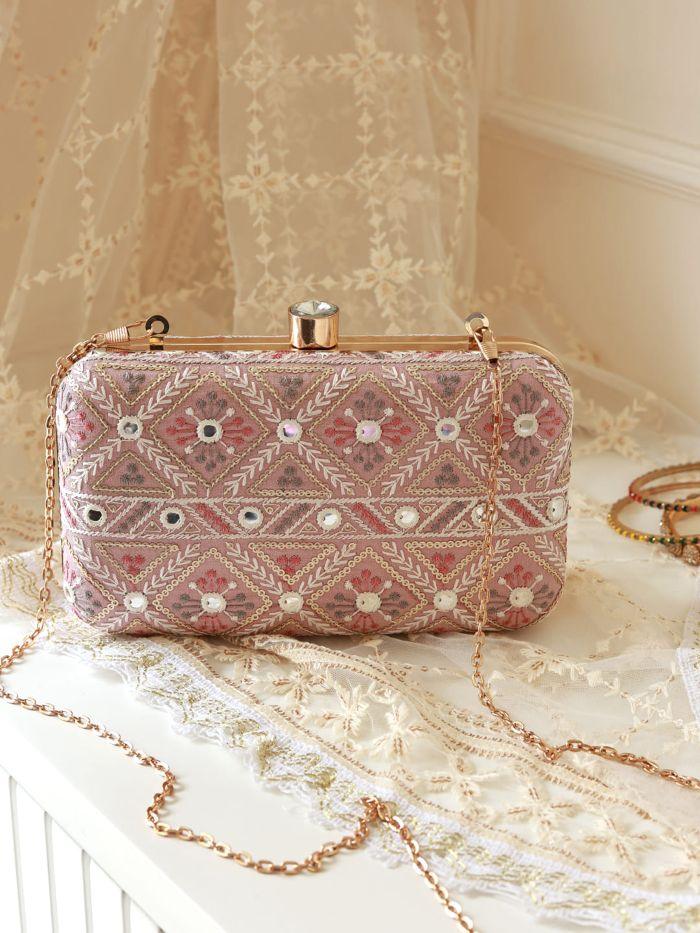 White Ariba box clutch by The Tan Clan, featuring a sleek rectangular design with a minimalist aesthetic and gold-tone clasp.