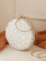 White round clutch by The Tan Clan featuring a sleek design and minimalist style for elegant evening occasions.