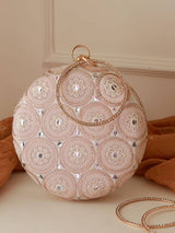 White Inaara round clutch bag by The Tan Clan, featuring a sleek, minimalist design with a smooth surface and compact size.